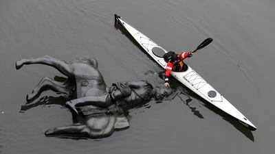 A replica equestrian statue of King Edward VII is nudged into position by Jon McCurley of art duo Life Of A Craphead in Toronto, Canada. Chris Helgren / Reuters