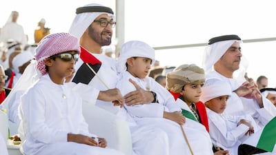 Sheikh Mohammed bin Zayed, sitting with Sheikh Saif bin Zayed, Deputy Prime Minister and Minister of Interior, right, as they watch a performance at the Sheikh Zayed Heritage Festival in Al Wathba on the UAE’s 42nd National Day in December. Ryan Carter / Crown Prince Court — Abu Dhabi