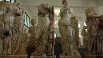 Dozens of statues from an archaeological site in the Cyrenaica region are stored inside a warehouse, locked away to keep looters from making off with them.