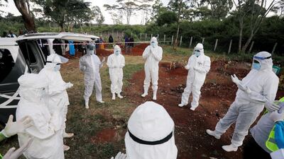 Volunteers from the National Muslim Covid-19 Response Committee pray before the burial of Abdullahi Adan, 52, at a cemetery in Nairobi, Kenya. Reuters