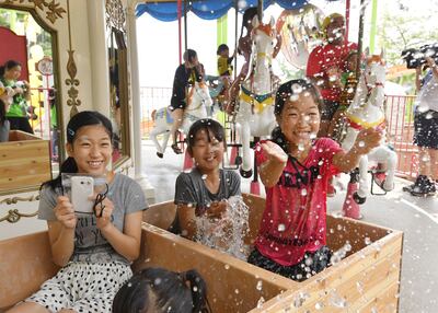 Children frolic while riding a hot-tub merry-go-round at Beppu Rakutenchi amusement park in Beppu, Oita Prefecture, on July 29, 2017. The southwestern Japan city boasting one of the world's largest hot spring resorts opened a special amusement park with rides featuring immersion in its thermal water, which will operate for three days through July 31 at the existing park. (Kyodo) ==Kyodo (Photo by Kyodo News via Getty Images)