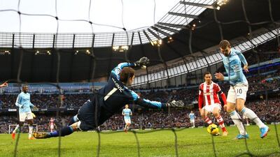Edin Dzeko, right, of Manchester City misses a close range shot on goal as Stoke City keeper Asmir Begovic looks on during their Premier League match at the Etihad Stadium on February 22, 2014. Clive Brunskill/Getty Images