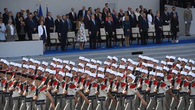 Donald Trump watches as members of the 4th Foreign Regiment march the annual Bastille Day military parade on the Champs-Elysees avenue in Paris. CHRISTOPHE ARCHAMBAULT/AFP
