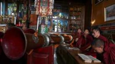 Exiled Tibetan Buddhist monks blow ceremonial horns during a prayer session at monastery in Dharmsala, India.