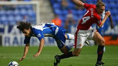 Fletcher, right, send's Wigan winger Jordi Gomez flying at the DW Stadium on Saturday.