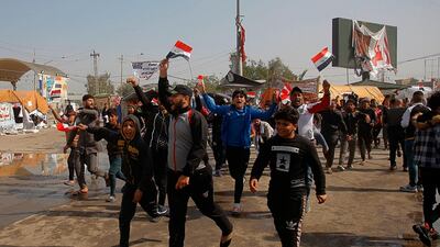 Protesters chant slogans during a protest to condemn the militia attack late-night Wednesday, in Najaf, Iraq. AP Photo