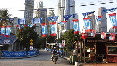 Campaign flags and banners with the Petronas Twin Towers in the background, Kuala Lumpur, Malaysia, May 8, 2018. Ore Huiying / Bloomberg