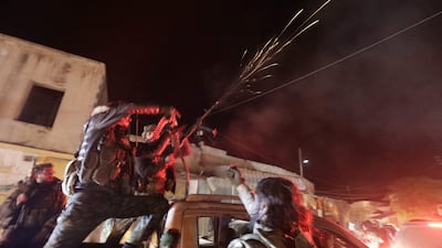 Anti-government fighters celebrate in the northern Syrian town of Tal Rifaat on Sunday. Syria remains divided into zones of influence dominated either by state forces or militias of different stripes – all of which enjoy the support of various foreign powers. AFP