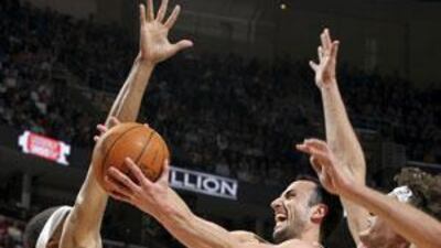 Manu Ginobili of the San Antonio Spurs, centre, is given no room by the Cleveland Cavaliers.