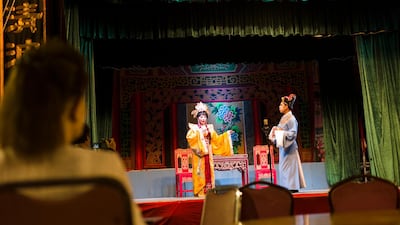 A guest watches the Chiu Chow opera performance. EPA