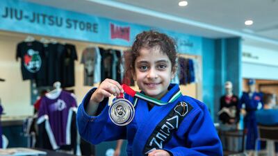 Mariam Akeil, 8, of Saudi Arabia proudly shows off her medal after winning bronze at the Abu Dhabi Jiu-Jitsu Festival. Victor Besa / The National