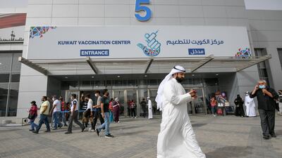 People queue for an anti-coronavirus vaccine at a makeshift inoculation centre in Kuwait. EPA