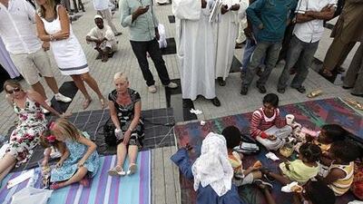 Families picnic beside each other during the Dubai World Cup at the Meydan racing facility.