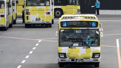A bus carrying passengers who disembarked the quarantined Diamond Princess cruise ship drives at Daikoku Pier on February 19, 2020 in Yokohama. Getty Images