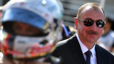 Azerbaijan’s president Ilham Aliyev walks on the grid before the start of the European Formula One Grand Prix at the Baku City Circuit. Andrej Isakovic / AFP