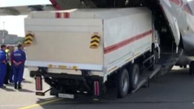 A Russian Emergencies Ministry's truck with humanitarian aid drives into a cargo plane heading to Beirut. REUTERS
