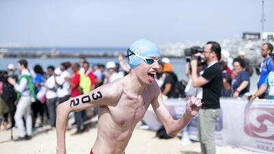Athletes reach the finish line at the Special Olympics World Games open water swimming competition in La Mer. Reem Mohammed / The National