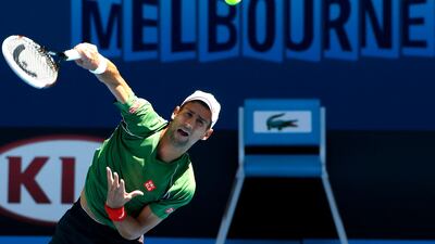 Novak Djokovic of Serbia serves during a training session ahead of the Australian Open tennis championship in Melbourne, Australia, Sunday, Jan. 12, 2014. (AP Photo/Eugene Hoshiko)