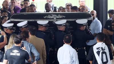 Pallbearers carry the casket of Pele at Santos' Urbano Caldeira Stadium. Reuters