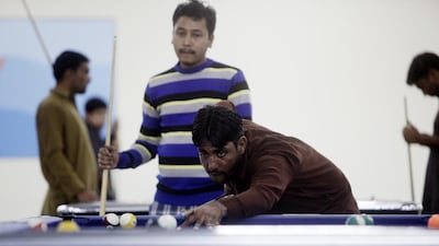 Workers play pool in one of the recreation centres. Christopher Pike / The National