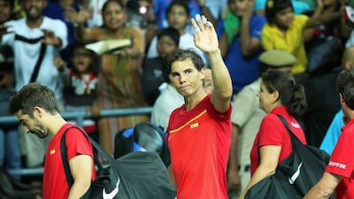 Rafael Nadal waves to the crowd after partnering Marc Lopez to doubles victory against India. Rajat Gupta / EPA
