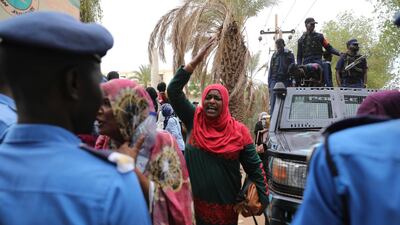 Family members of ousted Sudanese President Omar al-Bashir, who is on trial along with 27 co-accused, protest outside a courthouse in Khartoum, Sudan. AP Photo