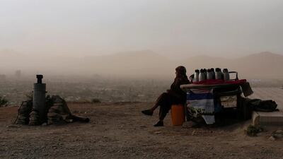 An Afghan man waits for customers at a tea stall on a hilltop, where people come for strolls, in Kabul on June 4. Ahmad Masood / Reuters