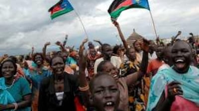 Residents of Abyei wave the southern Sudan flag as they celebrate last week's decision on the Abyei boundary.