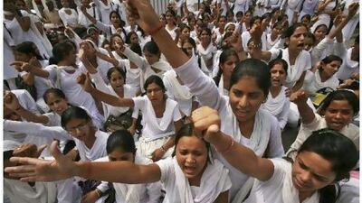 Supporters of activist Anna Hazare shout slogans during a protest against corruption in Jammu Saturday. India's parliament edged closer to an agreement on Saturday on an anti-corruption bill.