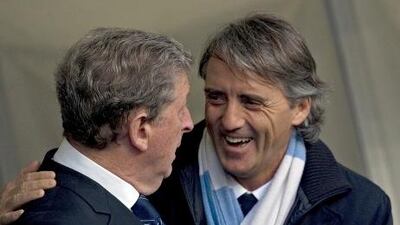 Roberto Mancini shares a joke with Roy Hodgson.