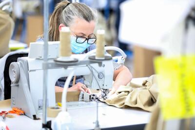 A machinist sews a protective gown for a worker in the U.K. National Health Service (NHS) at the Burberry Group Plc factory in Castleford, U.K., on Tuesday, April 21, 2020. The U.K. ran the risks running out of protective equipment for its hospital staff as half the doctors working in high-risk areas reported supply shortages in an April survey by the British Medical Association. Photographer: Chris Ratcliffe/Bloomberg