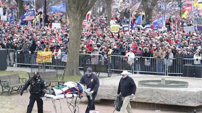 A person is removed on a stretcher as US President Donald J Trump delivers remarks to supporters gathered to protest Congress' upcoming certification of Joe Biden as the next president on the Ellipse in Washington, DC, USA. EPA