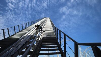 Technician Richira Nuwan carries out safety checks on the track of the Flying Aces ride at Ferrari World in Abu Dhabi. Ravindranath K / The National