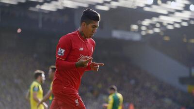Liverpool’s Roberto Firmino celebrates scoring the opener against Norwich City on Saturday. Jon Buckle / PA / AP