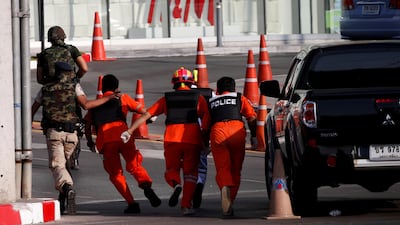 Soldiers cover rescue workers as they proceed to enter Terminal 21 shopping mall following a gun battle involving a Thai soldier on a shooting rampage, in Nakhon Ratchasima, Thailand. REUTERS