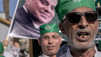 Egyptians celebrating the birth of the Prophet Muhammad with banners supporting President Abdel Fattah El Sisi in the December presidential elections. AP