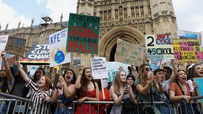 Climate change demonstrators hold placards during a march supported by Extinction Rebellion outside the Houses of Parliament in London, Britain on May 24, 2019. Reuters