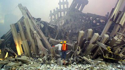 Rescue workers survey destruction to the World Trade Centre on September, 11 2001 in New York. AFP