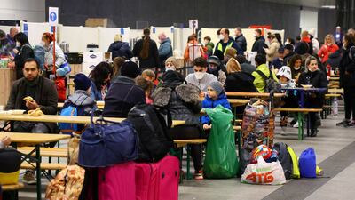 People fleeing from Ukraine eat and get some rest at a welcome centre in Berlin's Hauptbahnhof station. Reuters