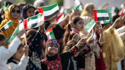 Children greet President Sheikh Mohamed at Nur Khan Air Base. Mohamed Al Hammadi / UAE Presidential Court