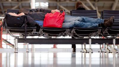 A man sleeps at the airport in Stuttgart, southern Germany. As many as 425,000 passengers were affected by the three-day strike of Lufthansa pilots. Sebastian Kahnert / AFP