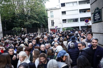 Dozens of people gather near the residence of former French president Nicolas Sarkozy as he leaves to enter prison in Paris. EPA