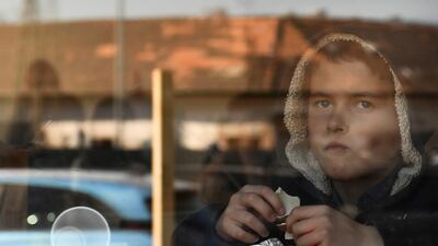 A young boy from Ukraine eats chocolate in a hostel in Budapest. AP