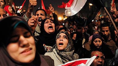Egyptian women, gathered at night in Tahrir Square, celebrate the news of the resignation of President Hosni Mubarak, who handed control of the country to the military on February 11.