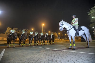Mounted police prepare to ride out on patrol in Abu Dhabi. Leslie Pableo for The National