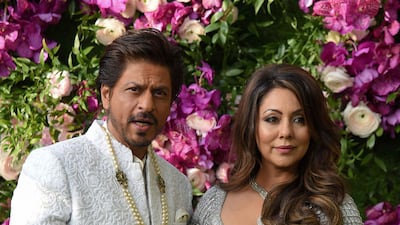 Bollywood actor Shah Rukh Khan (L) poses for photographs along with his wife and film producer Gauri Khan as they arrive to attend the wedding ceremony of Akash Ambani, son of Indian businessman Mukesh Ambani, in Mumbai on March 9, 2019. Photo: AFP