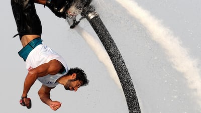 People compete in the flyboard section of the Dubai Watersports Summer Week.