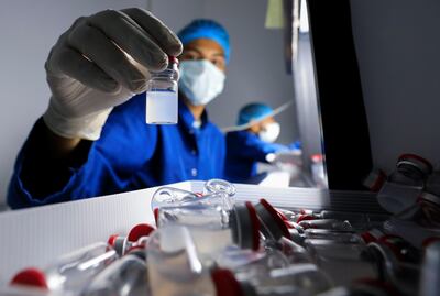 An Egyptian lab technician holds a vial of China's Sinovac COVID-19 vaccine. Reuters.