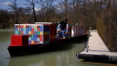 A pilot steers a scaled-down model of an ULCS container ship, named the 'Spirit of Port Revel', on a lake at the Port Revel Shiphandling Training Centre in Saint-Pierre-de-Bressieux, France. Reuters