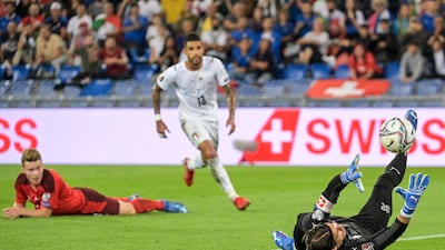 Switzerland goalkeeper Yann Sommer, right, saves a shot next to Italy's Emerson. AP